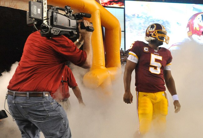 LANDOVER - SEPTEMBER 12:  Donovan McNabb #5 of the Washington Redskins prepares to run onto the field before the NFL season opener against the Dallas Cowboys at FedExField on September 12, 2010 in Landover, Maryland. The Redskins defeated the Cowboys 13-7. (Photo by Larry French/Getty Images)