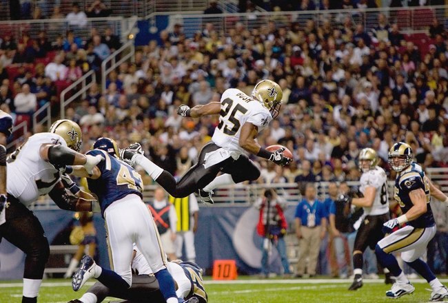 ST. LOUIS - NOVEMBER 15:  Reggie Bush #25 of the New Orleans Saints leaps for the endzone during the game against the St. Louis Rams at the Edward Jones Dome on November 15, 2009 in St. Louis, Missouri.  (Photo by Dilip Vishwanat/Getty Images)