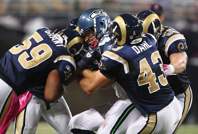 ST. LOUIS - OCTOBER 3: Anthony McCoy #85 of the Seattle Seahawks is stopped by Larry Grant #59, Craig Dahl #43 and James Laurinaitis #55 all of the St. Louis Rams at the Edward Jones Dome on October 3, 2010 in St. Louis, Missouri.  The Rams beat the Seahawks 20-3.  (Photo by Dilip Vishwanat/Getty Images)