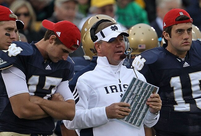 SOUTH BEND, IN - SEPTEMBER 25: Head coach Brian Kelly of the Notre Dame Fighting Irish along with quarterbacks (L-R) Nate Montana #16, Matthew Mulvey #17, Brian Castello and Tommy Rees #13 watch as their team takes on the Stanford Cardinal at Notre Dame Stadium on September 25, 2010 in South Bend, Indiana. Stanford defeated Notre Dame 37-14. (Photo by Jonathan Daniel/Getty Images)