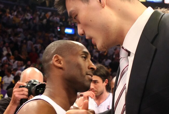 LOS ANGELES, CA - MAY 17:  Kobe Bryant #24 of the Los Angeles Lakers hugs Yao Ming #11 of the Houston Rockets after the Lakers defeated the Rockets 89-70 in Game Seven of the Western Conference Semifinals during the 2009 NBA Playoffs at Staples Center on May 17, 2009 in Los Angeles, California. NOTE TO USER: User expressly acknowledges and agrees that, by downloading and or using this photograph, User is consenting to the terms and conditions of the Getty Images License Agreement.  (Photo by Stephen Dunn/Getty Images)