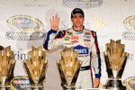 HOMESTEAD, FL - NOVEMBER 22:  Jimmie Johnson, driver of the #48 Lowe's Chevrolet, poses with all four of his championship trophies after winning the NASCAR Sprint Cup Series Championship at Homestead-Miami Speedway on November 22, 2009 in Homestead, Florida. Johnson becomes the first driver in the history of NASCAR to win four consecutive championships since the sports inception in 1949.  (Photo by Sam Greenwood/Getty Images)