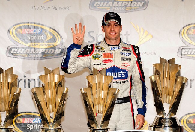 HOMESTEAD, FL - NOVEMBER 22:  Jimmie Johnson, driver of the #48 Lowe's Chevrolet, poses with all four of his championship trophies after winning the NASCAR Sprint Cup Series Championship at Homestead-Miami Speedway on November 22, 2009 in Homestead, Florida. Johnson becomes the first driver in the history of NASCAR to win four consecutive championships since the sports inception in 1949.  (Photo by Sam Greenwood/Getty Images)