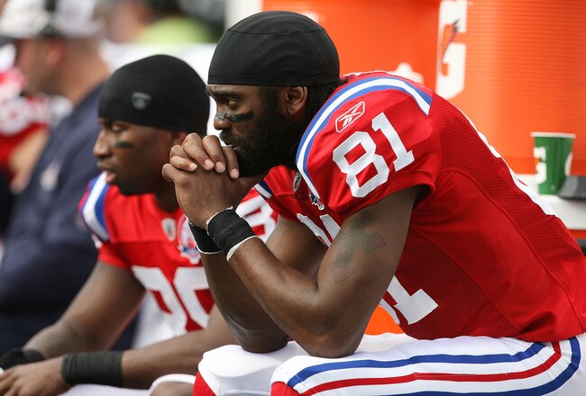 MIAMI - DECEMBER 06:  Wide receivers Sam Aiken #88 and Randy Moss #81 of the New England Patriots sit on the sidelines while taking on the Miami Dolphins at Land Shark Stadium on December 6, 2009 in Miami, Florida. The Dolphins defeated the Patriots 22-21.  (Photo by Doug Benc/Getty Images)
