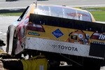 KANSAS CITY, KS - OCTOBER 03:  Crew members work on the car of Kyle Busch, driver of the #18 M&M's Toyota, during the NASCAR Sprint Cup Series Price Chopper 400 on October 3, 2010 in Kansas City, Kansas.  (Photo by Rusty Jarrett/Getty Images for NASCAR)