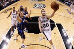 SAN ANTONIO - APRIL 29:  Guard Manu Ginobili #20 of the San Antonio Spurs takes a shot against Dirk Nowitzki #41 of the Dallas Mavericks in Game Six of the Western Conference Quarterfinals during the 2010 NBA Playoffs at AT&T Center on April 29, 2010 in San Antonio, Texas. NOTE TO USER: User expressly acknowledges and agrees that, by downloading and or using this photograph, User is consenting to the terms and conditions of the Getty Images License Agreement.  (Photo by Ronald Martinez/Getty Images)