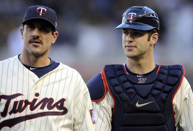 MINNEAPOLIS, MN - OCTOBER 7: Starting pitcher Carl Pavano #48 and catcher Joe Mauer #7 of the Minnesota Twins walk to the dugout prior to game two of the ALDS game against the New York Yankees on October 7, 2010 at Target Field in Minneapolis, Minnesota.  (Photo by Hannah Foslien/Getty Images)