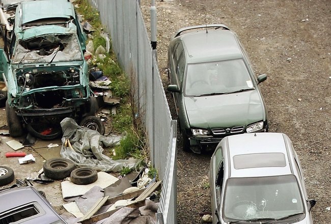 LONDON - APRIL 20:  Rubbish and abandoned cars lie on the road in the Marshgate Lane Industrial Area on April 20, 2006 in London, England.  International Olympic Committee inspectors are in London this week to scrutinise the city's preparations for hosting the 2012 Games. Hosting the 2012 Olympic Games is expected to transform the area into a state of the art sporting hub, but hundreds of businesses will have to relocate as they are due to be bulldozed to make way for the Games.  (Photo by Scott Barbour/Getty Images)