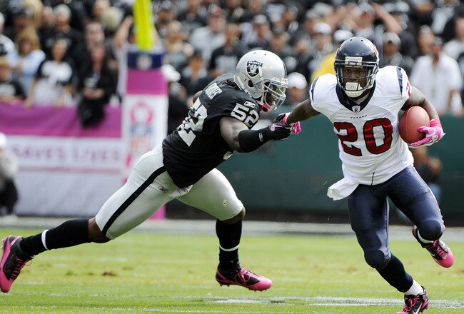 OAKLAND, CA - OCTOBER 3: Running back Steve Slaton #20 of the Houston Texans pushes away from linebacker Quentin Groves #52 of the Oakland Raiders during an NFL football game October 3, 2010 at The Oakland-Alameda County Coliseum in Oakland, California.  (Photo by Thearon W. Henderson/Getty Images)