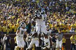 ANN ARBOR, MI - OCTOBER 09:  Chris Rucker #29 of the Michigan State Spartans celebrate with his teammates after intercepting Denard Robinson #16 of the Michigan Wolverines during the fourth quarter of the game on October 9, 2010 at Michigan Stadium in Ann Arbor, Michigan. The Michigan Spartans defeated the Michigan Wolverines 34-17  (Photo by Leon Halip/Getty Images)