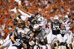 AUBURN, AL - SEPTEMBER 25:  Quarterback Cameron Newton #2 of the Auburn Tigers dives across the offensive and defensive lines for a touchdown against the South Carolina Gamecocks before it was called back for a false start at Jordan-Hare Stadium on September 25, 2010 in Auburn, Alabama.  (Photo by Kevin C. Cox/Getty Images)