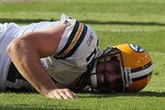 LANDOVER, MD - OCTOBER 10:  Aaron Rodgers #12 of the Green Bay Packers lays on the ground after a hard hit against the Washington Redskins in the fourth quarter at FedExField on October 10, 2010 in Landover, Maryland. The Redskins won the game in overtime 16-13.  (Photo by Win McNamee/Getty Images)