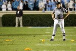 CHAPEL HILL, NC - NOVEMBER 07:  A referee stands in the middle of four penalty flags that were all thrown on the same play during a rivalry game between the Duke Blue Devils and North Carolina Tar Heels at Kenan Stadium on November 7, 2009 in Chapel Hill, North Carolina.  (Photo by Streeter Lecka/Getty Images)