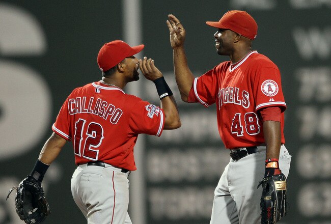 BOSTON - AUGUST 19:  Torii Hunter #48 and Alberto Callaspo #12 of the Los Angeles Angels of Anaheim celebrate the win over the Boston Red Sox on August 19, 2010 at Fenway Park in Boston, Massachusetts. The Angels defeated the Red Sox 7-2.  (Photo by Elsa/Getty Images)