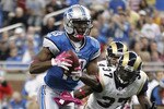 DETROIT - OCTOBER 10:  Nate Burleson #13 of the Detroit Lions scores a third quarter touchdown on a 21 yard pass from Shaun Hill #14 during the third quarter of the game against the St. Louis Rams during the second quarter of the game at Ford Field on October 10, 2010 in Detroit, Michigan.  The Lions defeated the Rams 44-6.  (Photo by Leon Halip/Getty Images)
