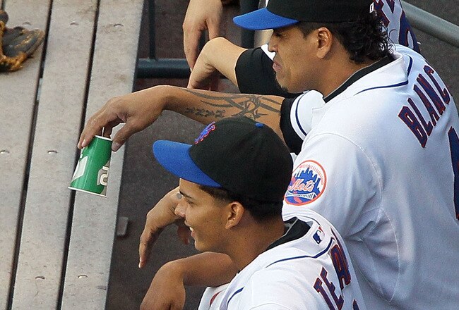 NEW YORK - JULY 05:  Jose Reyes #7 of the New York Mets talks with teammates Jesus Feliciano #27, Henry Blanco #4, and Ruben Tejada #11 before playing the Cincinnati Reds on July 5, 2010 at Citi Field in the Flushing neighborhood of the Queens borough of New York City.  (Photo by Jim McIsaac/Getty Images)