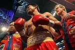 ARLINGTON, TX - MARCH 13:  Manny Pacquiao of the Philippines looks on in the ring with trainer Freddie Roach while taking on Joshua Clottey of Ghana during the WBO welterweight title fight at Cowboys Stadium on March 13, 2010 in Arlington, Texas. Pacquiao defeated Clottey by unanimous decision.  (Photo by Jed Jacobsohn/Getty Images)