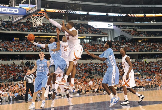 ARLINGTON, TX - DECEMBER 19:  Dexter Strickland #5 of the North Carolina Tar Heels takes a shot against Dexter Pittman #34 of the Texas Longhorns at Cowboys Stadium on December 19, 2009 in Arlington, Texas.  (Photo by Ronald Martinez/Getty Images)