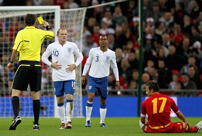 LONDON, ENGLAND - OCTOBER 12:  Wayne Rooney of England is shown the yellow card by Referee Manuel Grafe during the UEFA EURO 2012 Group G Qualifying match between England and Montenegro at Wembley Stadium on October 12, 2010 in London, England.  (Photo by Hamish Blair/Getty Images)