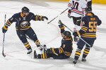 BUFFALO, NY - OCTOBER 11: Jordon Leopold #3, Derek Roy #9 and Jochen Hecht #55  of the Buffalo Sabres celebrate Roy's goal in the first period against the Chicago Blackhawks at HSBC Arena on October 11, 2010 in Buffalo, New York.  (Photo by Rick Stewart/Getty Images)