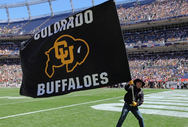 DENVER - SEPTEMBER 04:  A supporter of the Colorado Buffaloes waives a flag in the endzone against the Colorado State Rams in the Rocky Mountain Showdown at INVESCO Field at Mile High on September 4, 2010 in Denver, Colorado.  (Photo by Doug Pensinger/Getty Images)