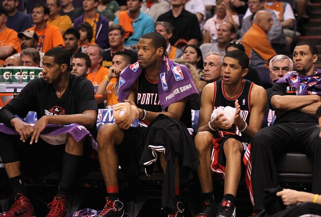 PHOENIX - APRIL 26:  (L-R) LaMarcus Aldridge #12, Marcus Camby #21, Nicolas Batum #88 and Brandon Roy #7 of the Portland Trail Blazers react on the bench during Game Five of the Western Conference Quarterfinals of the 2010 NBA Playoffs against the Phoenix Suns at US Airways Center on April 26, 2010 in Phoenix, Arizona. The Suns defeated the Trail Blazers 107-88 to take a 3-2 series lead.  NOTE TO USER: User expressly acknowledges and agrees that, by downloading and or using this photograph, User is consenting to the terms and conditions of the Getty Images License Agreement.  (Photo by Christian Petersen/Getty Images)