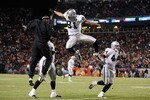 DENVER - DECEMBER 20:  Chaz Schilens #81 of the Oakland Raiders is congratulated by Javon Walker (L) after scoring a touchdown late in the fourth quarter against the Denver Broncos at Invesco Field at Mile High on December 20, 2009 in Denver, Colorado. The Raiders defeated the Broncos 20-19. (Photo by Jeff Gross/Getty Images)