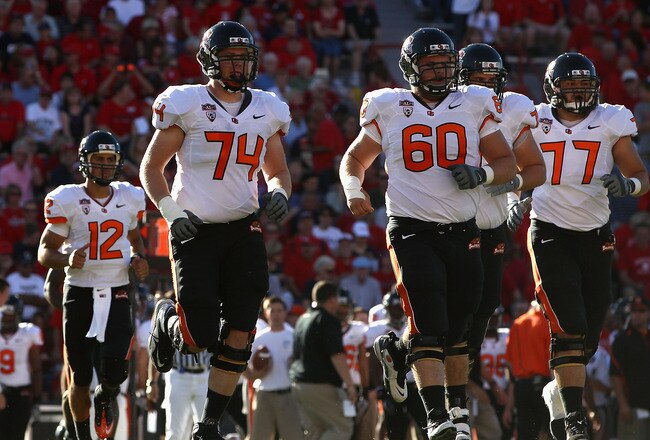 TUCSON, AZ - OCTOBER 09:  (L-R) Ryan Katz #12, Burke Ellis #74, Alex Linnenkohl #60 and Michael Philipp #77 of the Oregon State Beavers during the college football game against the Arizona Wildcats at Arizona Stadium on October 9, 2010 in Tucson, Arizona. The Beavers defeated the Wildcats 29-27.  (Photo by Christian Petersen/Getty Images)
