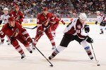 GLENDALE, AZ - MARCH 04:  Peter Mueller #88 of the Colorado Avalanche skates with the puck past Derek Morris #53 and Lee Stempniak #22 of the Phoenix Coyotes during the third period of the NHL game at Jobing.com Arena on March 4, 2010 in Glendale, Arizona. The Coyotes defeated the Avalanche 3-1. (Photo by Christian Petersen/Getty Images)