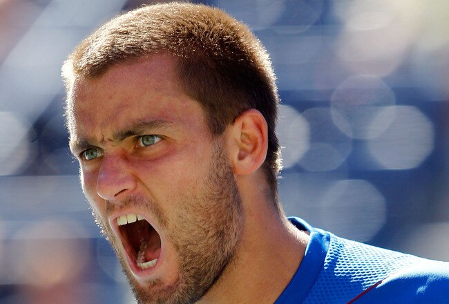 NEW YORK - SEPTEMBER 11:  Mikhail Youzhny of Russia reacts while playing against Rafael Nadal of Spain during his men's singles semifinal match on day thirteen of the 2010 U.S. Open at the USTA Billie Jean King National Tennis Center on September 11, 2010 in the Flushing neighborhood of the Queens borough of New York City.  (Photo by Matthew Stockman/Getty Images)