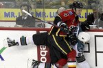 CALGARY, AB -APRIL 6: Jay Bouwmeester #4 of the Calgary Flames pins Manny Malhotra #27 of the San Jose Sharks against the boards in the second period of NHL action on April 6, 2010 at the Pengrowth Saddledome in Calgary, Alberta. (Photo by Mike Ridewood/Getty Images)