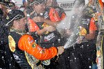 CONCORD, NC - OCTOBER 16:  Jamie McMurray, driver of the #1 Bass Pro Shops/Tracker Boats Chevrolet, celebrates in victory lane after winning  the NASCAR Sprint Cup Series Bank of America 500 at Charlotte Motor Speedway on October 16, 2010 in Concord, North Carolina.  (Photo by Geoff Burke/Getty Images)