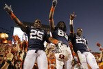 AUBURN - OCTOBER 16:  Linebacker Daren Bates #25, wide receiver Darvin Adams #89 and running back Onterio McCalebb #23 of the Auburn Tigers celebrate with the crowd after the game against the Arkansas Razorbacks at Jordan-Hare Stadium on October 16, 2010 in Auburn, Alabama.  The Tigers beat the Razorbacks 65-43.  (Photo by Mike Zarrilli/Getty Images)