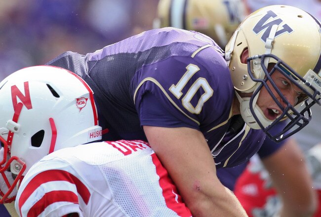 SEATTLE - SEPTEMBER 18: Quarterback Jake Locker #10 of the Washington Huskies is tackled by linebacker Lavonte David #4 of the Nebraska Cornhuskers on September 18, 2010 at Husky Stadium in Seattle, Washington. (Photo by Otto Greule Jr/Getty Images)