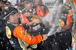 CONCORD, NC - OCTOBER 16:  Jamie McMurray, driver of the #1 Bass Pro Shops/Tracker Boats Chevrolet, celebrates in victory lane after winning  the NASCAR Sprint Cup Series Bank of America 500 at Charlotte Motor Speedway on October 16, 2010 in Concord, North Carolina.  (Photo by Geoff Burke/Getty Images)