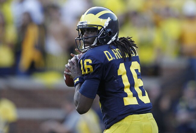 ANN ARBOR, MI - OCTOBER 09:  Denard Robinson #16 of the Michigan Wolverines drops back to pass during the game against the Michigan State Spartans on October 9, 2010 at Michigan Stadium in Ann Arbor, Michigan. The Michigan State Spartans defeated the Michigan Wolvereines 34-17.  (Photo by Leon Halip/Getty Images)