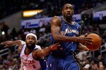 LOS ANGELES, CA - DECEMBER 14:  Gilbert Arenas #0 of the Washington Wizards drives to the basket as Baron Davis #1 of the Los Angeles Clippers lunges to steal the ball in the first half at Staples Center on December 14, 2009 in Los Angeles, California. NOTE TO USER: User expressly acknowledges and agrees that, by downloading and/or using this Photograph, user is consenting to the terms and conditions of the Getty Images License Agreement.  (Photo by Jeff Gross/Getty Images)