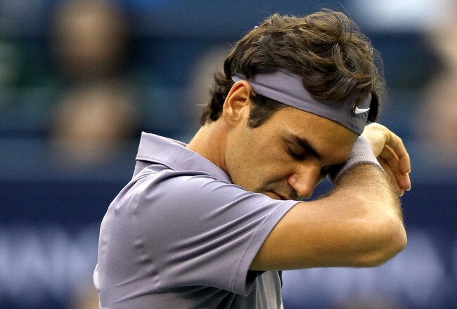 SHANGHAI, CHINA - OCTOBER 17:  Roger Federer of Switzerland wipes his forehead between points while playing Andy Murray of Great Britain during the final on day seven of the 2010 Shanghai Rolex Masters at the Shanghai Qi Zhong Tennis Center on October 17, 2010 in Shanghai, China.  (Photo by Matthew Stockman/Getty Images)