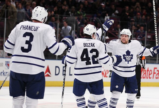 NEW YORK - OCTOBER 15: Phil Kessel #81 of the Toronto Maple Leafs celebrates his overtime winning goal with teamates against Henrik Lundqvist  of the New York Rangers during their game on October 15, 2010 at Madison Square Garden in New York City.  (Photo by Al Bello/Getty Images)