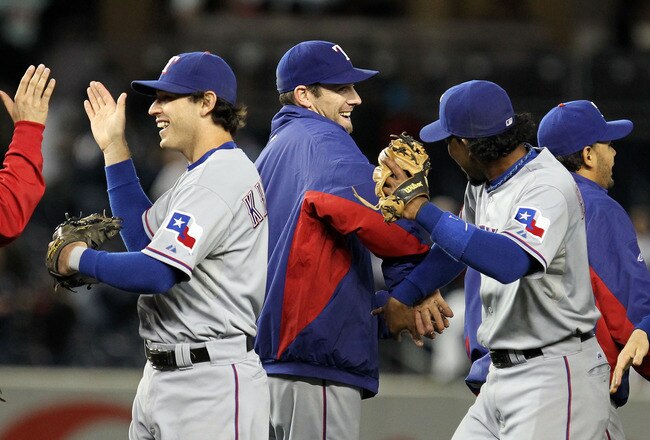 NEW YORK - OCTOBER 18:  (L-R) Ian Kinsler #5, Cliff Lee #33 and Elvis Andrus #1 of the Texas Rangers celebrate after the Rangers won 8-0 against the New York Yankees in Game Three of the ALCS during the 2010 MLB Playoffs at Yankee Stadium on October 18, 2010 in New York, New York.  (Photo by Al Bello/Getty Images)