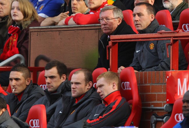 MANCHESTER, ENGLAND - OCTOBER 16:  Sir Alex Ferguson the manager of Manchester United and Wayne Rooney look on from the bench during the Barclays Premier League match between Manchester United and West Bromwich Albion at Old Trafford on October 16, 2010 in Manchester, England.  (Photo by Alex Livesey/Getty Images)