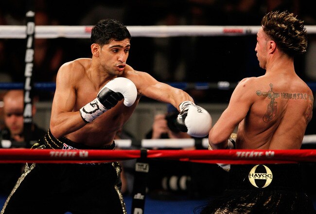 NEW YORK - MAY 15:  Amir Khan (L) of Great Britain hits Paulie Malignaggi during the WBA light welterweight title fight at Madison Square Garden on May 15, 2010 in New York City.  (Photo by Chris Trotman/Getty Images)