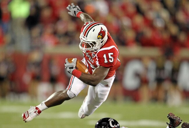 LOUISVILLE, KY - OCTOBER 15:  Bilal Powell #15 of  the Louisville Cardinals runs with the ball while tackled by Reuben Johnson #5 of the Cincinnati Bearcats during the game at Papa John's Cardinal Stadium on October 15, 2010 in Louisville, Kentucky.  (Photo by Andy Lyons/Getty Images)