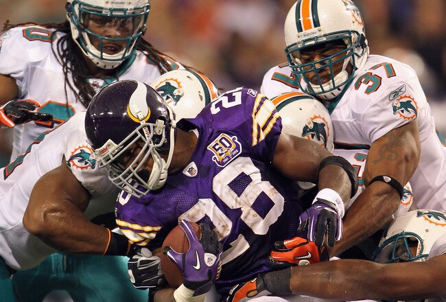 MINNEAPOLIS - SEPTEMBER 19:  Adrian Peterson #28 of the Minnesota Vikings carries the ball as he is tackled by the Miami Dolphins defense during the first half of the game on September 19, 2010 at Hubert H. Humphrey Metrodome in Minneapolis, Minnesota.  (Photo by Jamie Squire/Getty Images)