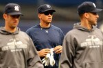 NEW YORK - OCTOBER 20:  Alex Rodriguez #13 of the New York Yankees walks on the field with Jorge Posada #20 (R) and Derek Jeter #2 during batting practice against the Texas Rangers in Game Five of the ALCS during the 2010 MLB Playoffs at Yankee Stadium on October 20, 2010 in the Bronx borough of New York City.  (Photo by Al Bello/Getty Images)