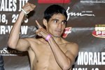 LAS VEGAS - NOVEMBER 17:  Erik Morales of Mexico points to his hand and during the official weigh-in for his bout against Manny Pacquiao of the Philippines at the Thomas & Mack Center on November 17, 2006 in Las Vegas, Nevada. The boxers will meet for the third time for a super featherweight bout on November 18, 2006. (Photo by Ethan Miller/Getty Images)