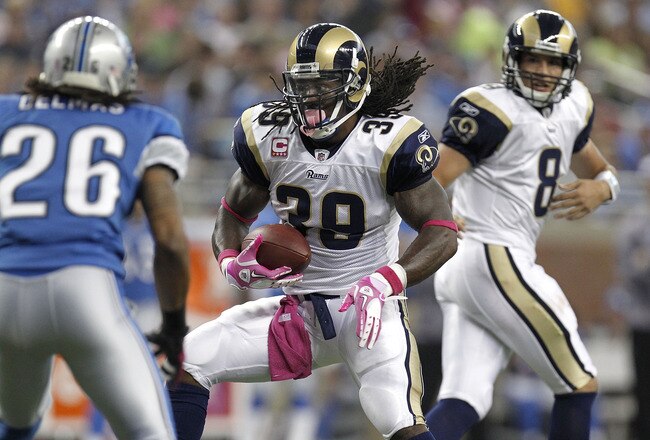 DETROIT - OCTOBER 10:  Steven Jackson #39 of the St. Louis Rams takes a handoff from Sam Bradford and tries to get around the tackle of Louis Delmas #26 of the Detroit Lions on October 10, 2010 at Ford Field in Detroit, Michigan.  (Photo by Gregory Shamus/Getty Images)