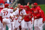 ST. LOUIS - OCTOBER 2: Matt Holliday #7 of the St. Louis Cardinals is congratulated by teammates after hitting a walk-off single against the Colorado RockiesI at Busch Stadium on October 2, 2010 in St. Louis, Missouri.  The Cardinals beat the Rockies 1-0 in 11 innings.  (Photo by Dilip Vishwanat/Getty Images)