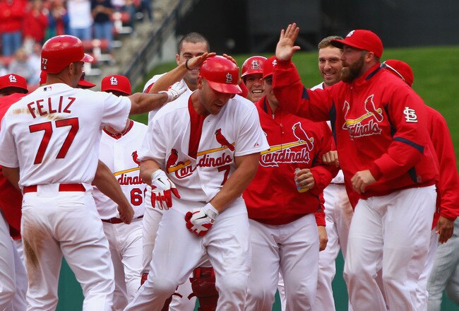 ST. LOUIS - OCTOBER 2: Matt Holliday #7 of the St. Louis Cardinals is congratulated by teammates after hitting a walk-off single against the Colorado RockiesI at Busch Stadium on October 2, 2010 in St. Louis, Missouri.  The Cardinals beat the Rockies 1-0 in 11 innings.  (Photo by Dilip Vishwanat/Getty Images)