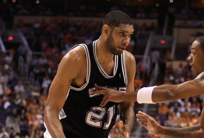PHOENIX - MAY 05:  Tim Duncan #21 of the San Antonio Spurs handles the ball during Game Two of the Western Conference Semifinals of the 2010 NBA Playoffs against the Phoenix Suns at US Airways Center on May 5, 2010 in Phoenix, Arizona. The team is wearing 'Los Suns' jerseys on Cinco de Mayo in response to an anti-immigration law recently passed in Arizona.  The Suns defeated the Spurs 110-102 to take a 2-0 series lead.  NOTE TO USER: User expressly acknowledges and agrees that, by downloading and or using this photograph, User is consenting to the terms and conditions of the Getty Images License Agreement.  (Photo by Christian Petersen/Getty Images)